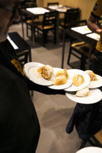 server_delivering_dishes_at_Conga_restaurant_Porto